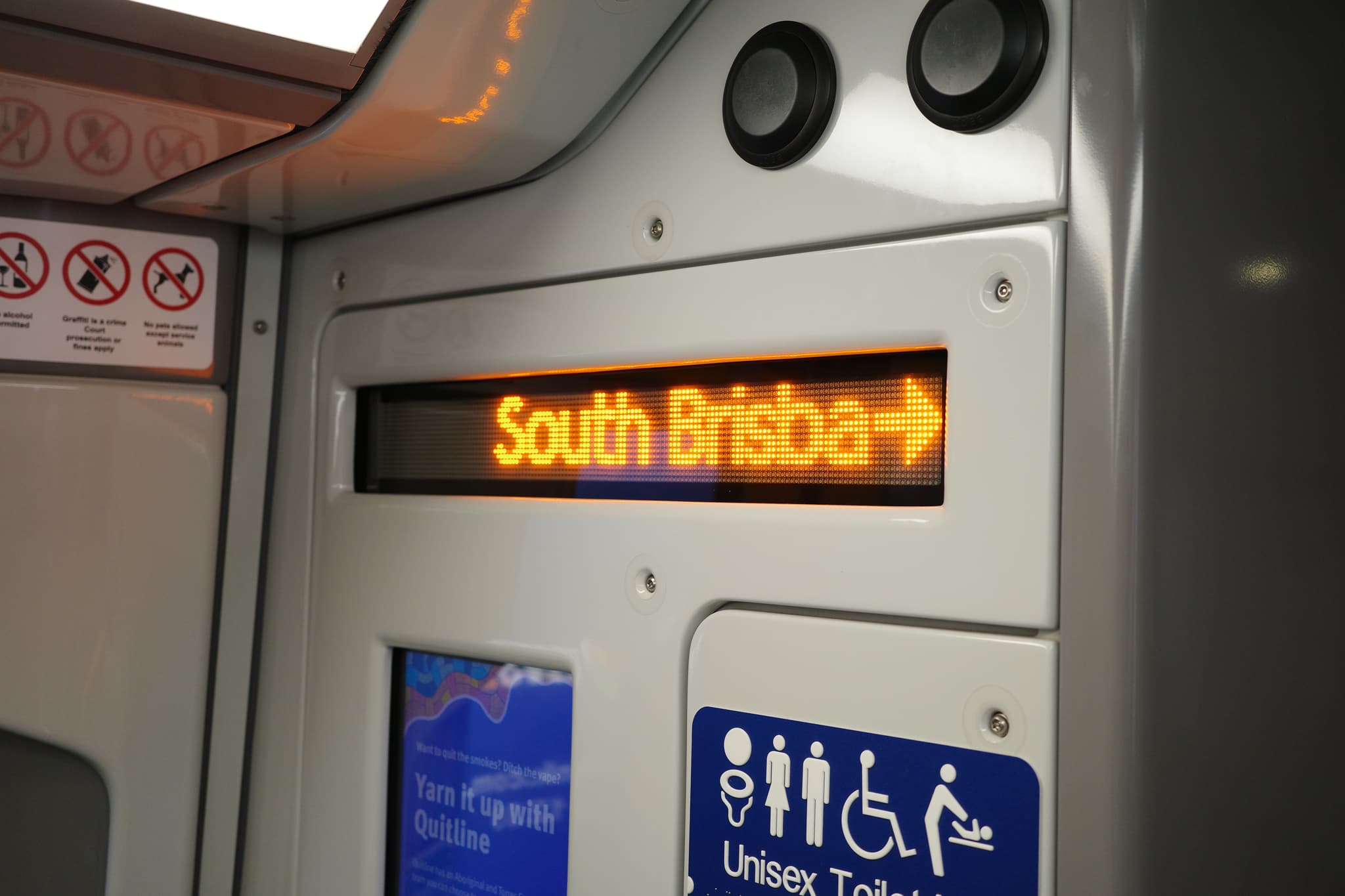 Electronic destination display reading “South Ruislip” inside a train, with London Underground signage and accessibility icons nearby