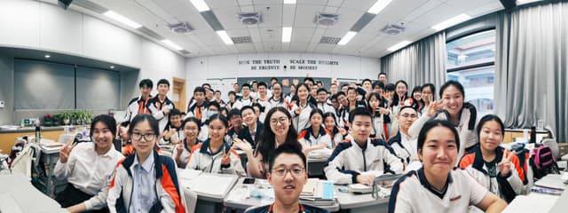 A group of students smiling and posing for a photo in a classroom setting